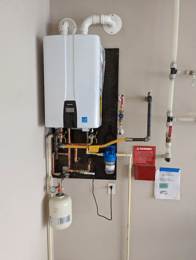 Professional plumber installing copper piping in a Northgate home